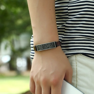 Retro brown leather bracelet featuring engraved inspirational metal plate on wrist