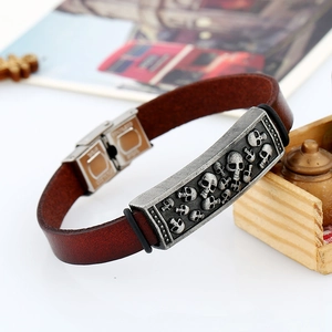 Vintage men's brown leather bracelet with silver skull embossed metal plate detail