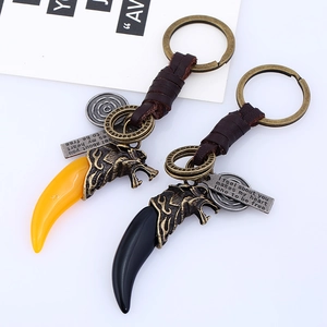 Vintage braided leather keychain with bronze wolf head and resin fang pendant accessories