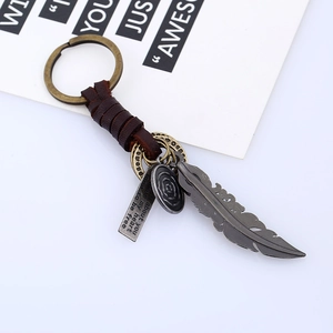 Vintage braided leather keychain with bronze feather pendant and engraved inspirational tag