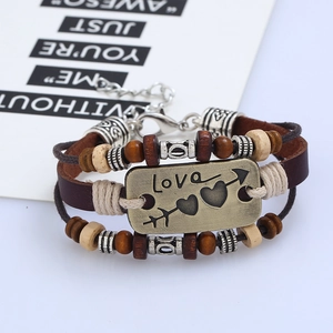 Multilayer leather bracelet with bronze love plaque and wooden beads on white background