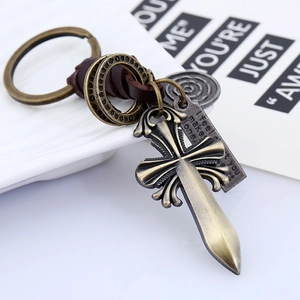 Vintage braided leather keychain with bronze cross sword pendant and engraved tag