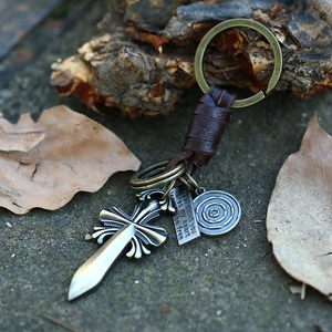 Vintage woven leather keychain with bronze cross pendant and engraved metal plate tag