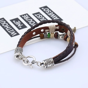 Detail of multi-layer leather bracelet with wooden beads and silver metal tube charms