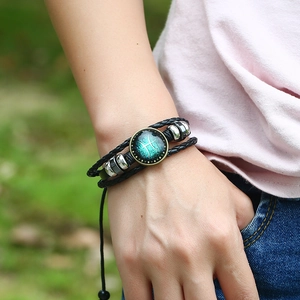 Bracciale Pesci fatto a mano in pelle intrecciata con ciondolo in vetro bronzo e perline