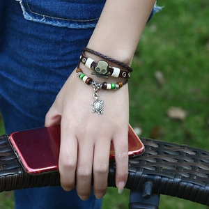 Men's punk leather bracelet with bronze skull and sea turtle charm on multi-layered beads