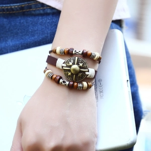 Handmade multilayer bohemian leather bracelet featuring wooden beads and vintage metal star charm