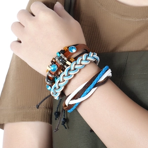 Bohemian multilayer woven leather bracelet set with blue rhinestones on a female wrist