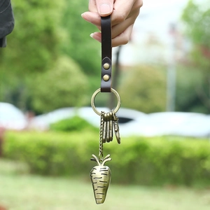Vintage carrot alloy keychain with brown leather strap and brass metal charms for bags