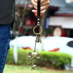 Vintage bronze elephant keychain with leather strap and heart-shaped key pendant