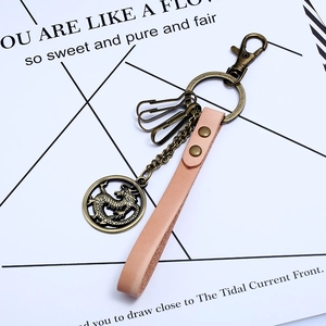 Vintage alloy dragon keychain with light camel leather strap and bronze metal hooks