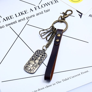 Vintage bronze alloy keychain with leather strap and cathedral relief at a 45-degree angle