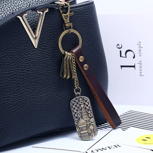 Vintage bronze alloy keychain with leather strap and cathedral pendant on black bag