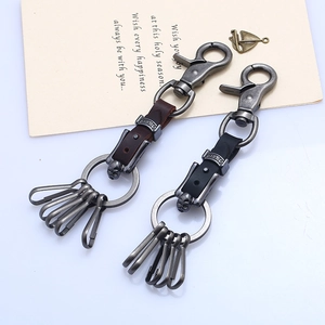 Set of two vintage leather and metal keychains with skull charms and carabiners for men