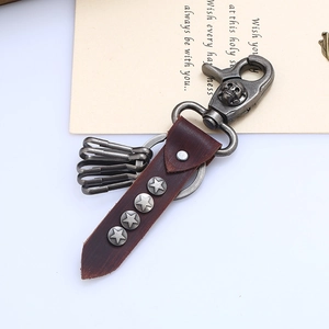Retro genuine leather keychain with skull clasp and metallic stars on brown strap