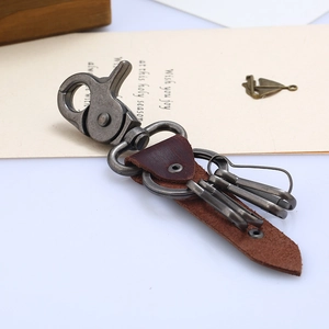 Retro brown genuine leather keychain with bronze zinc alloy hooks on white surface