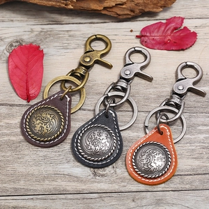 Retro punk leather keychains with vintage metal motifs in bronze and silver finishes