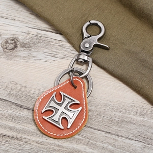 Vintage orange leather keychain with cross medallion and gunmetal lobster clasp