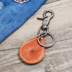 Vintage leather keychain with orange-brown teardrop pendant and metallic lobster clasp