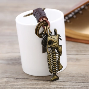 Retro bronze fish bone keychain with dark brown braided leather strap and metal tags