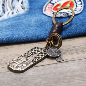 Retro punk hand-woven leather keychain with bronze cathedral pendant and metal charms