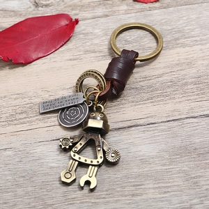 Retro steampunk robot keychain with bronze alloy finish and braided dark brown leather strap