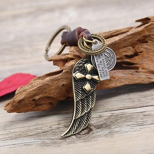 Vintage leather keychain with bronze metal wings, cross charm and engraved heart plaque