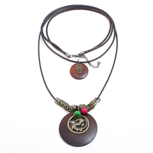 Vintage long dragon necklace with brown wooden pendants and bronze alloy charms