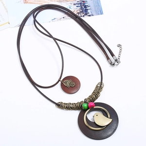 Bohemian multi-layer long necklace with Hamsa hand and wooden bird pendant on brown cord