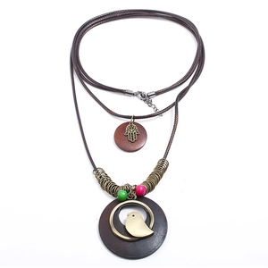 Bohemian multilayer sweater necklace with Hamsa Hand and wooden beads in vintage style