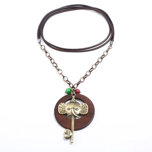 Collier vintage avec éléphant en bronze, breloque clé et anneau en bois sur cordon ciré