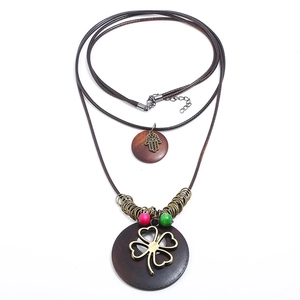 Vintage bronze alloy leaf necklace with layered hamsa hand and clover wooden pendants