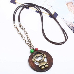 Ethnic retro long necklace with wooden cartoon pendant and beads on white background