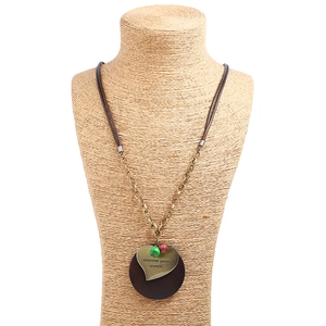 Vintage heart and wood pendant necklace with engraved text on manikin stand