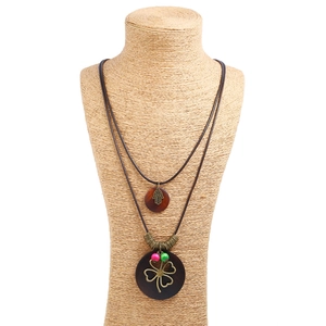 Vintage long bronze alloy necklace with layers of wooden pendants and leaf details