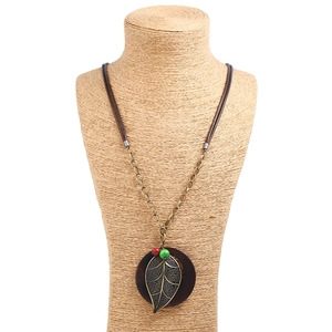 Vintage long necklace with bronze leaf pendant on wood base and wax cord detail