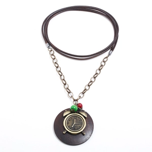 Vintage steampunk sweater necklace featuring a bronze alarm clock on dark wood pendant