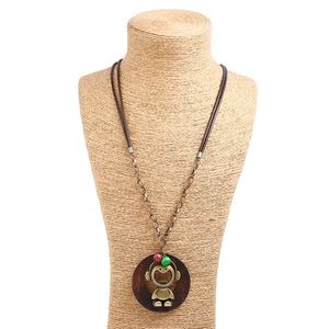 Retro long necklace with wooden ring and cartoon headphone character pendant on a mannequin
