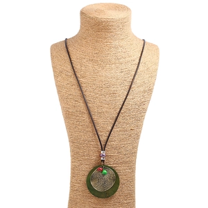 Ethnic wax cord long necklace with round wood and bronze pendant on neck model