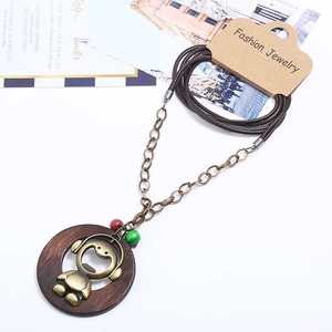 Retro long necklace with wooden ring and bronze figure pendant on multi-strand braided cord