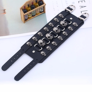 Detailed macro view of black wide leather punk bracelet with silver skull metal studs