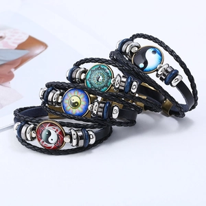 Four punk-style multilayer braided leather bracelets with Yin Yang glass cabochon charms