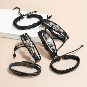 Detail of 6-piece men's vintage black leather bracelets with skull and anchor charms