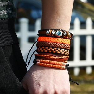 Multi-layer leather bracelet set with orange braided ropes and evil eye charm detail