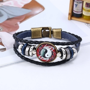 Detail of multi-layer leather bracelet with Tai Chi Yin Yang pendant and bronze buckle