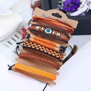 Detailed view of 6-piece multilayer braided leather bracelets with evil eye charm on card
