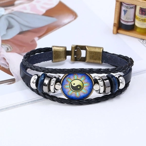 Detail of multi-layer braided leather bracelet with Yin Yang symbol and bronze buckle