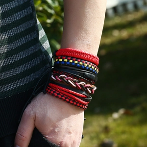 Retro multi-layer leather bracelet set with woven punk style cords on a model wrist