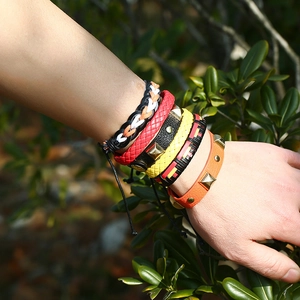 Handmade vintage woven leather bracelet set with metallic studs and colorful braids