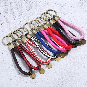 Detailed overhead view of assorted braided leather keychains in nine vibrant colors